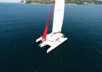 trimaran yacht open hoist red genaker sail